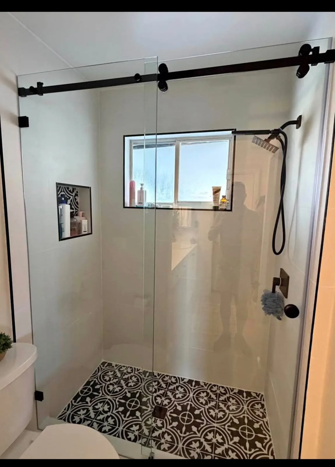 Tiled shower and black sliding door
